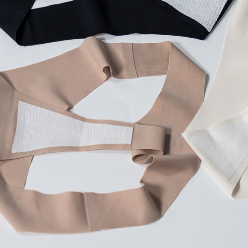 Flat lay of Gudia seamless Brazilian underwear in multiple colors including grey, showing waistband softness and antibacterial cotton gusset