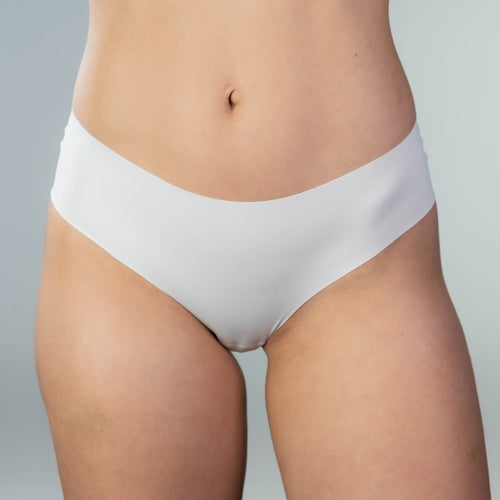 Front close-up view of model wearing Gudia white seamless Brazilian underwear with soft waistband and organic cotton crotch designed for second-skin comfort