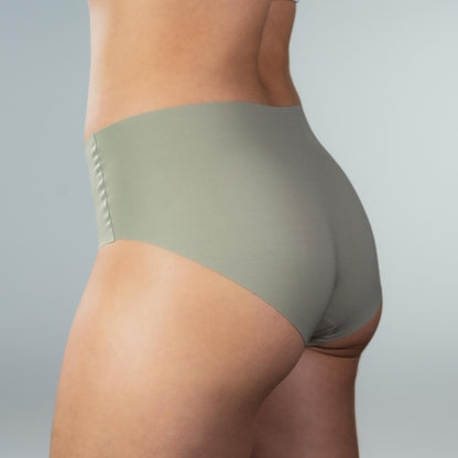 Side-back close-up of model wearing Gudia green seamless hipster with full coverage fit seamless edges and organic cotton crotch for soft stretch comfort