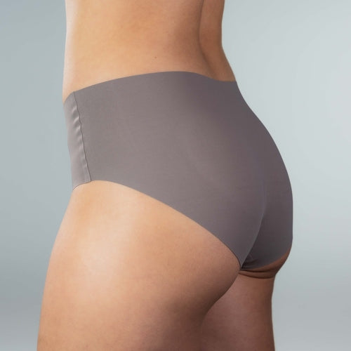 Side-back close-up of model wearing Gudia grey seamless hipster with soft stretch fit seamless edge and organic cotton crotch for breathable comfort