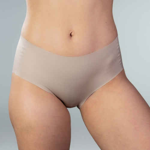 Front view of model wearing Gudia sand seamless hipster with mid-rise V-shaped waistband and organic cotton crotch for soft breathable daily comfort