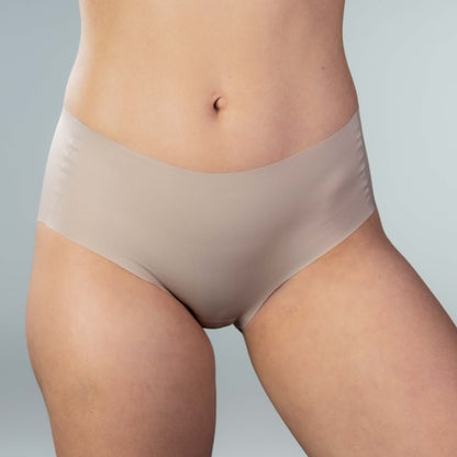 Front view of model wearing Gudia sand seamless hipster with mid-rise V-shaped waistband and organic cotton crotch for soft breathable daily comfort