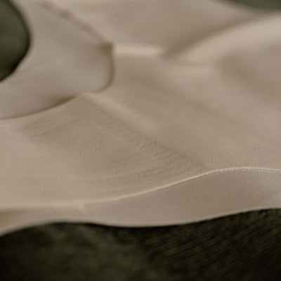Close-up texture of Gudia seamless Brazilian underwear in white, showcasing ultra-soft stretch fabric and breathable organic cotton crotch lining
