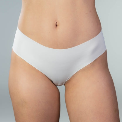 Front close-up view of model wearing Gudia white seamless Brazilian underwear with soft waistband and organic cotton crotch designed for second-skin comfort