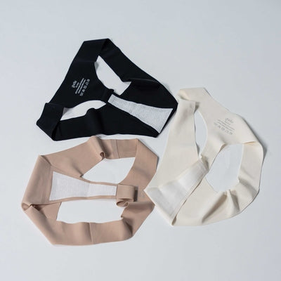 Close-up of Gudia seamless thongs in black, sand, and white, breathable triangle-hole design and 100% organic cotton crotch for daily freshness