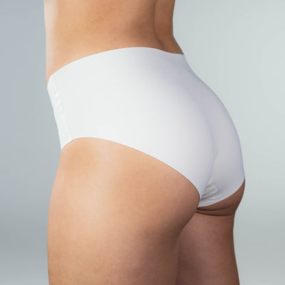 Side-back close-up of model wearing Gudia white seamless hipster with soft stretch fit and organic cotton crotch for breathable invisible comfort